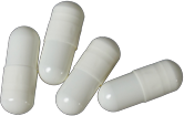 four white medication capsules