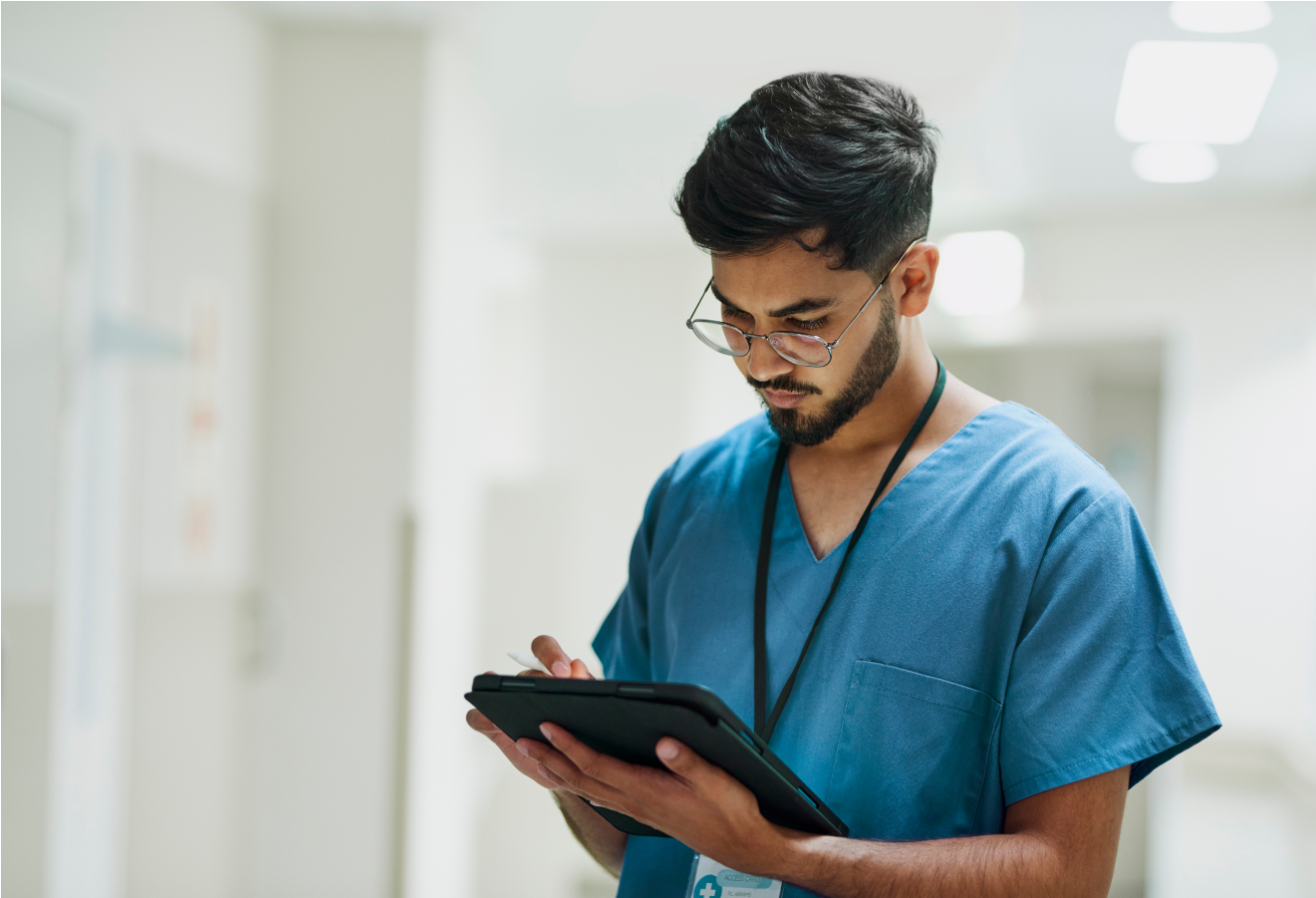 Male vet with beard working on a tablet