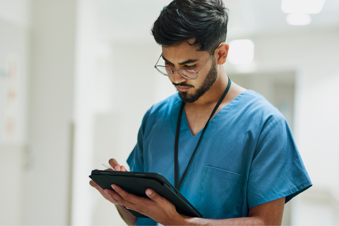 Male vet with beard working on a tablet