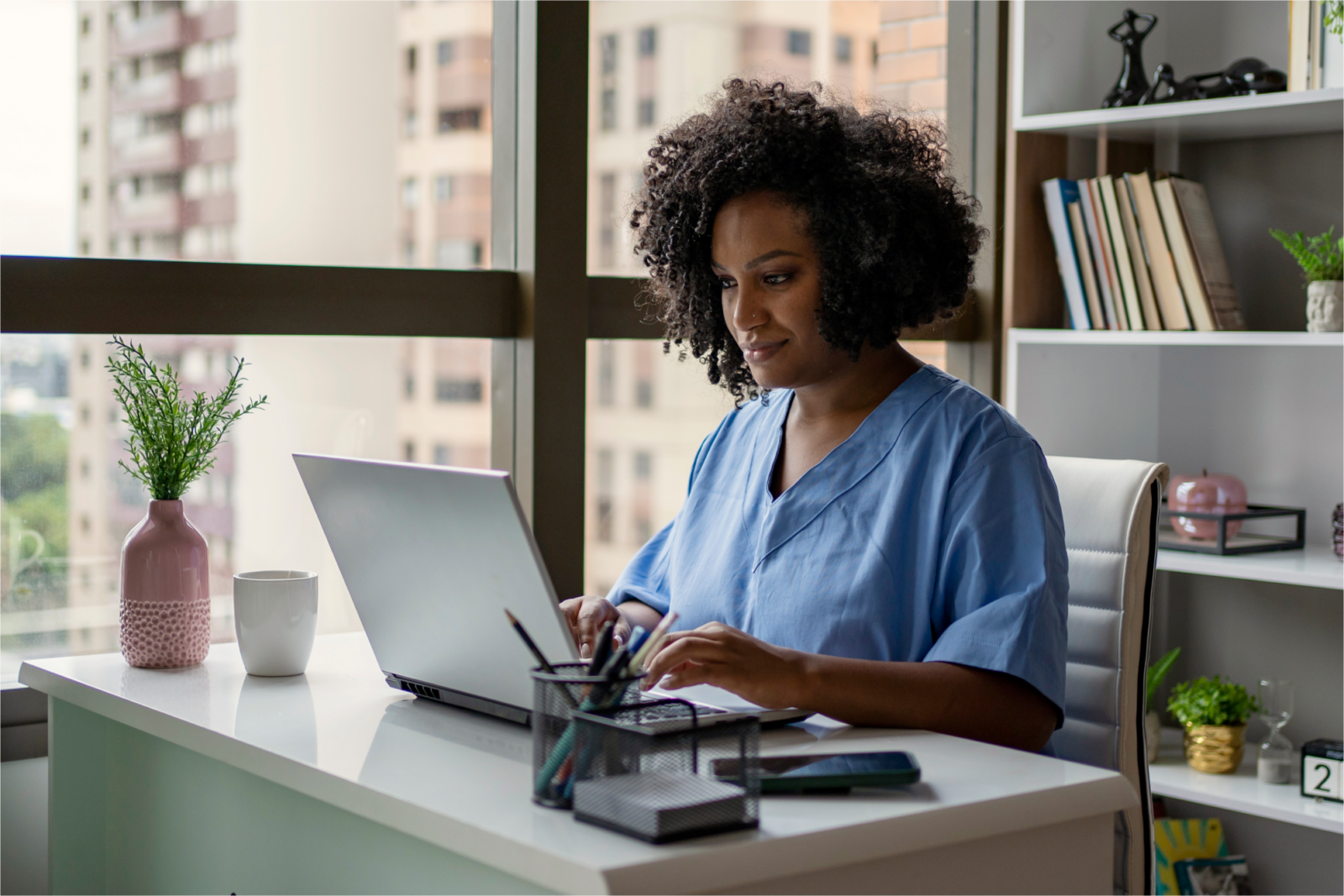 Female vet working on a laptop at her desk