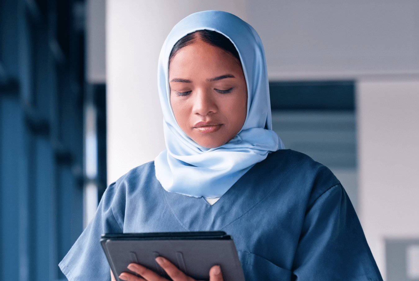 A female tech using a tablet with calm focus