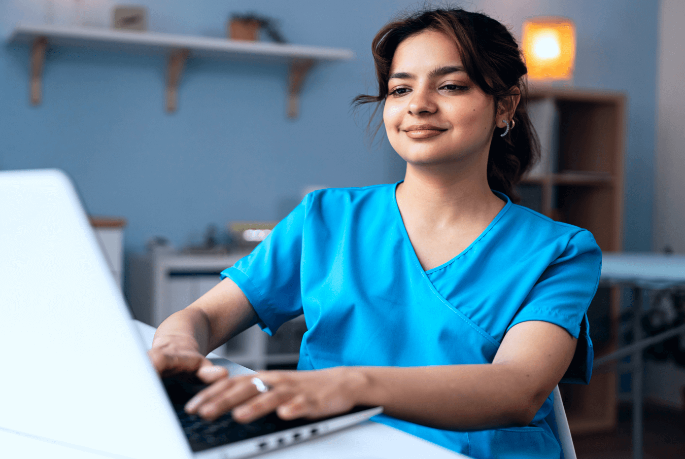 A female vet working on a laptop while smiling contentedly.