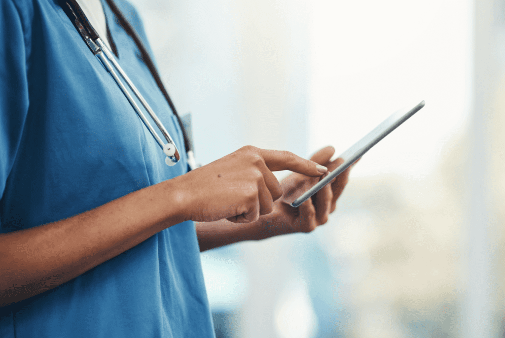 Vet with stethescope around her neck touching her smartphone screen