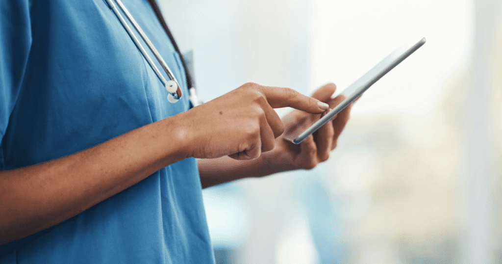 Vet with stethescope around her neck touching her smartphone screen