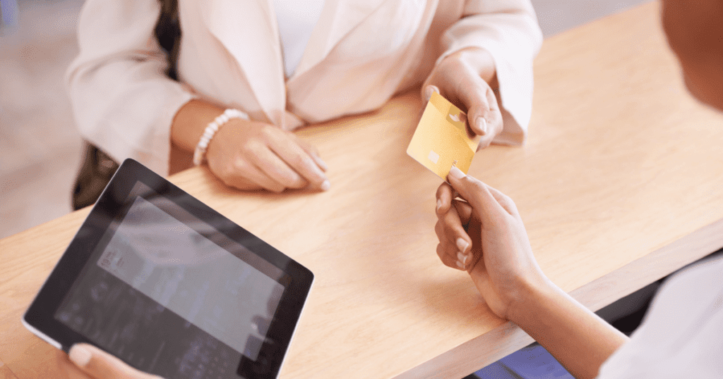 Pet parent making a credit card payment at the point of sale.